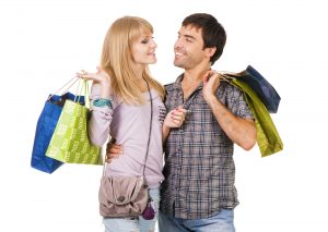 Cheerful young couple with shopping bags, isolated on white back